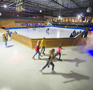 Visitors speed around the ice track on their skates at the Snowdome